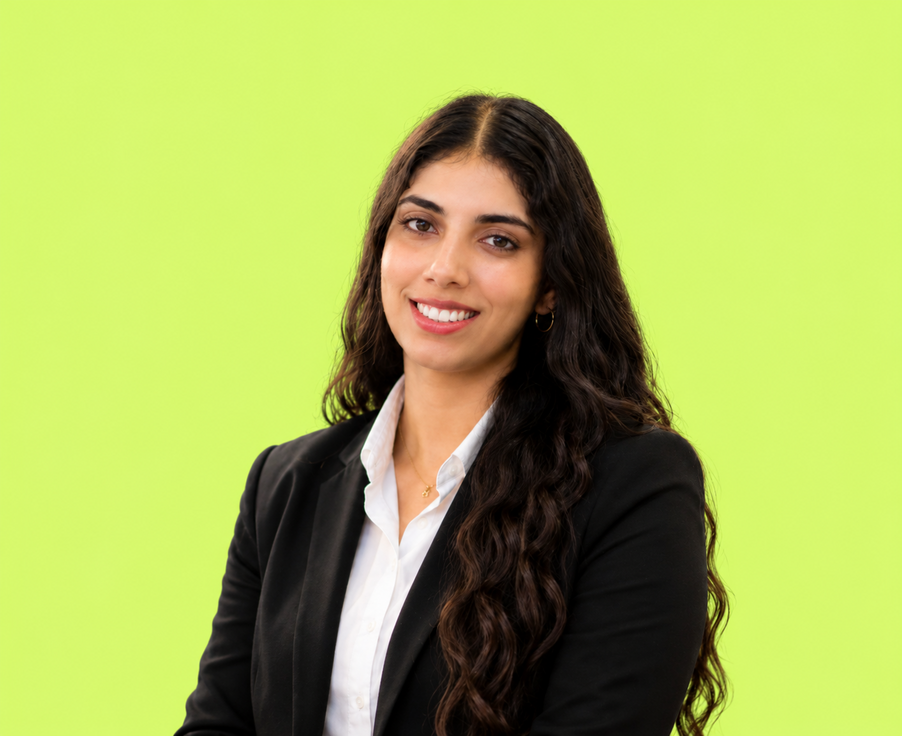 Portrait of Simranjit Kaur in a black blazer against a lime background
